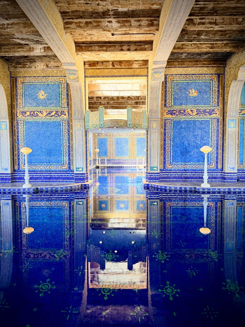The indoor Roman Pool at Hearst Castle covered in intricate blue and gold mosaic tile