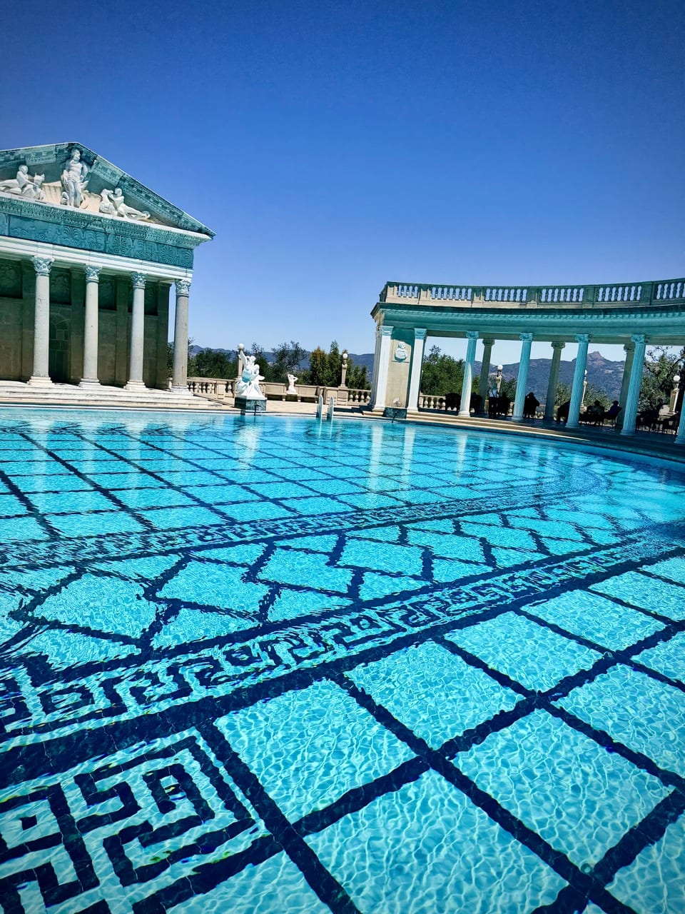 The turquoise Neptune Pool at Hearst Castle surrounded by marble colonnades and statues